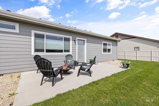 back of property with an outdoor fire pit and a patio area