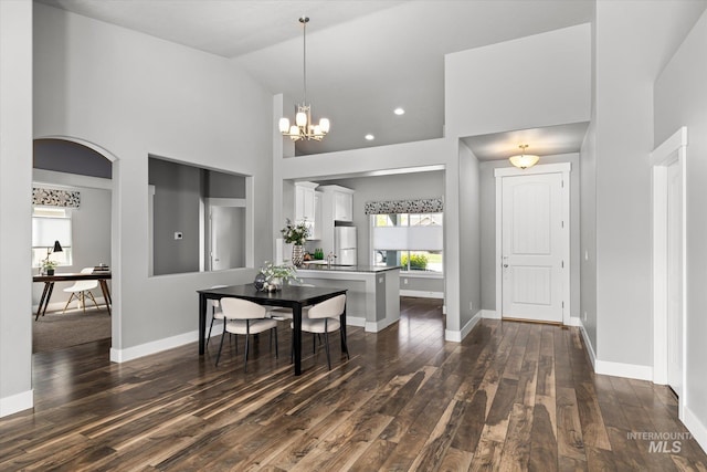dining area featuring healthy amount of natural light, dark wood-style floors, baseboards, high vaulted ceiling, and recessed lighting