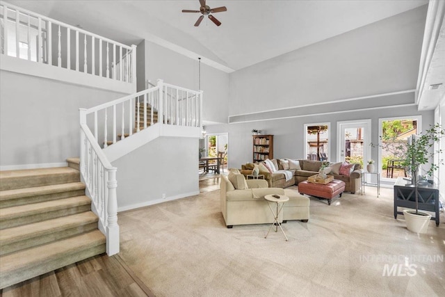 living room featuring ceiling fan, high vaulted ceiling, and carpet