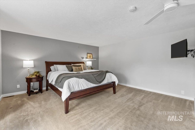 bedroom with light carpet and a textured ceiling