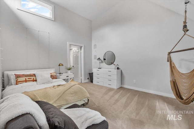 carpeted bedroom featuring high vaulted ceiling