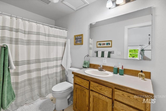 bathroom featuring vanity, tile patterned flooring, and toilet