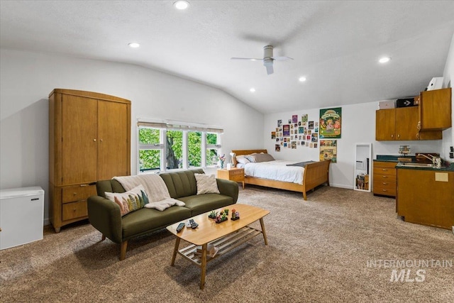 carpeted bedroom with ceiling fan, lofted ceiling, and a textured ceiling