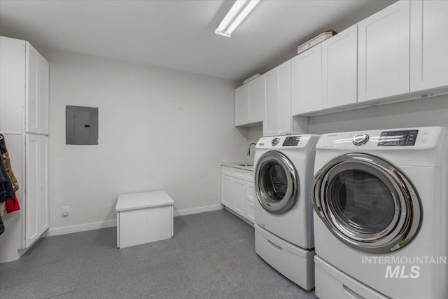 clothes washing area with cabinets, electric panel, washer and clothes dryer, and sink