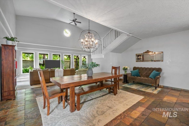 dining room featuring a chandelier and high vaulted ceiling
