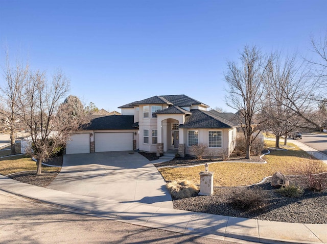 view of front of property featuring an attached garage, driveway, and stucco siding