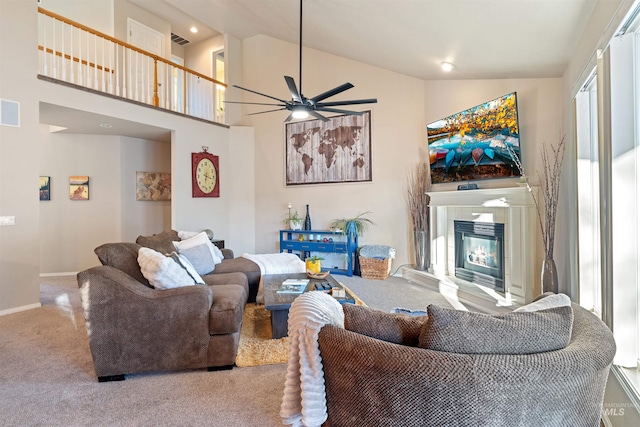 carpeted living room featuring high vaulted ceiling, a tile fireplace, visible vents, and ceiling fan