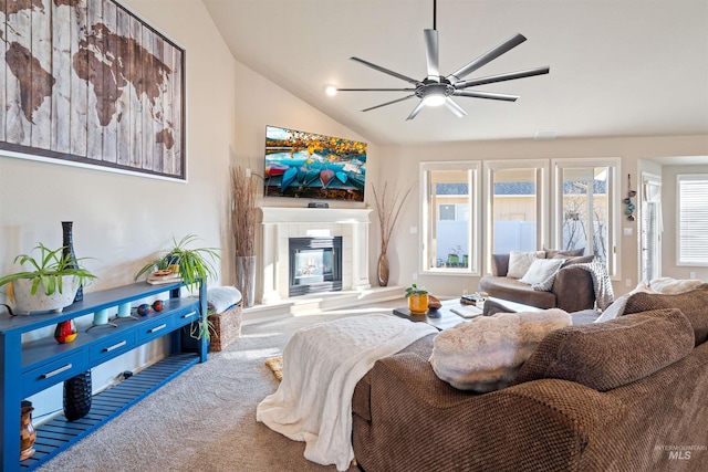 carpeted living area featuring a ceiling fan, lofted ceiling, and a tile fireplace