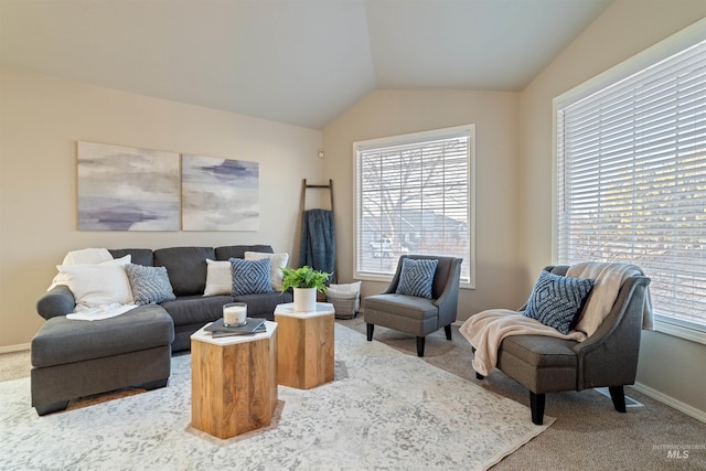 living room with lofted ceiling, carpet floors, and a healthy amount of sunlight