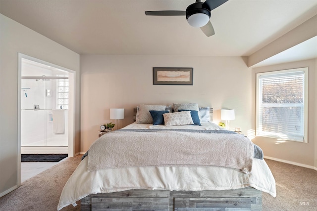 bedroom featuring carpet floors, baseboards, ensuite bath, and a ceiling fan