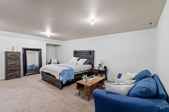 bedroom with light carpet, a textured ceiling, visible vents, and baseboards