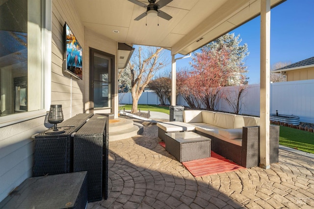 view of patio featuring an outdoor hangout area, a fenced backyard, and a ceiling fan