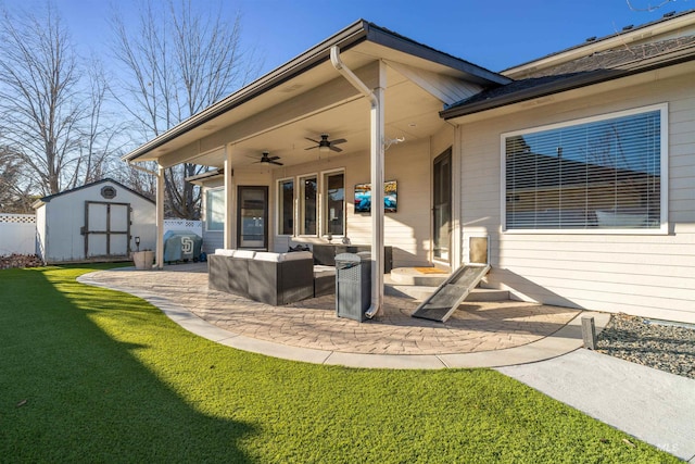 view of patio featuring a storage unit, outdoor lounge area, ceiling fan, fence, and an outdoor structure