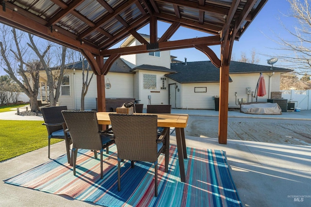 view of patio / terrace featuring a gazebo, fence, and outdoor dining space