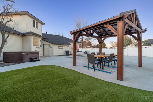 view of yard featuring a patio area, a fenced backyard, a hot tub, and a gazebo