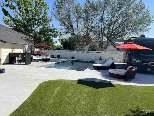 view of swimming pool with a lawn, a patio area, a fenced backyard, and a fenced in pool