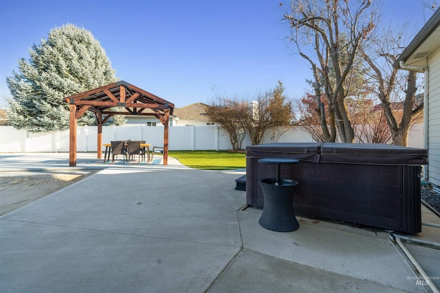 view of patio / terrace featuring a gazebo, a fenced backyard, and a hot tub