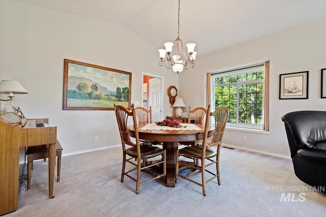 dining room with a chandelier, light carpet, baseboards, and vaulted ceiling