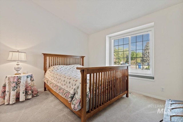 bedroom featuring carpet flooring, vaulted ceiling, and baseboards