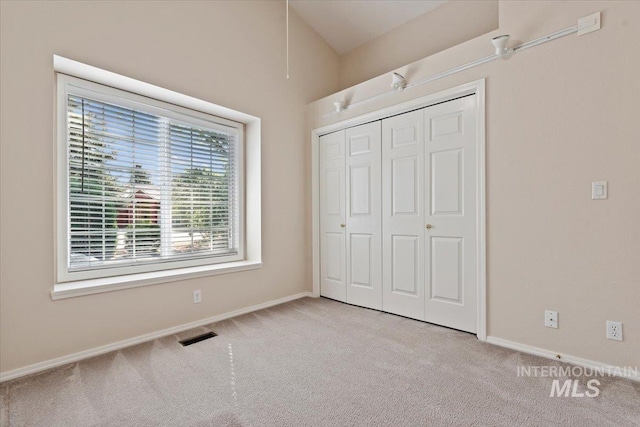 unfurnished bedroom featuring carpet flooring, baseboards, and a closet