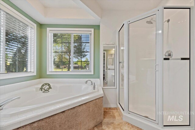 full bath featuring a bath, a shower stall, and tile patterned floors