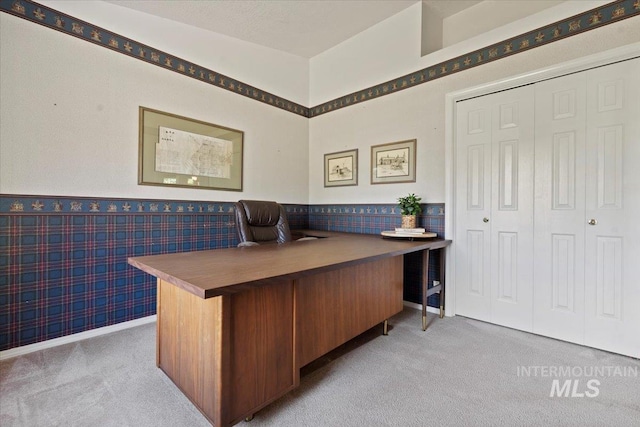office area featuring light colored carpet, a wainscoted wall, and wallpapered walls