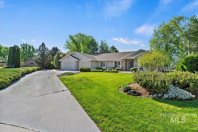 single story home featuring an attached garage, concrete driveway, and a front lawn