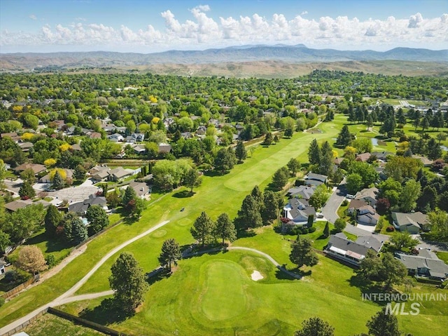 aerial perspective of suburban area with a golf club and a mountainous background