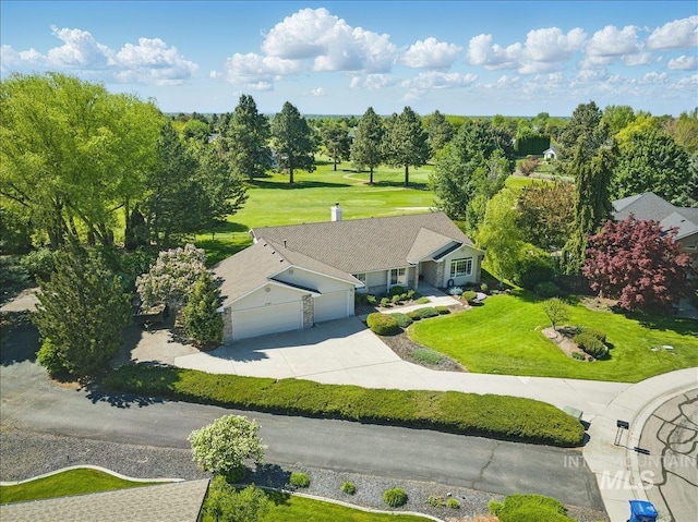 aerial view of property and surrounding area with a tree filled landscape