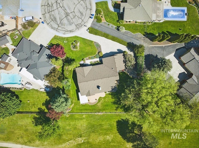 aerial perspective of suburban area featuring a pool