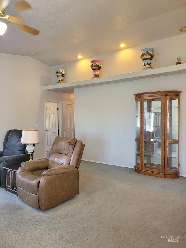 living area with carpet and ceiling fan