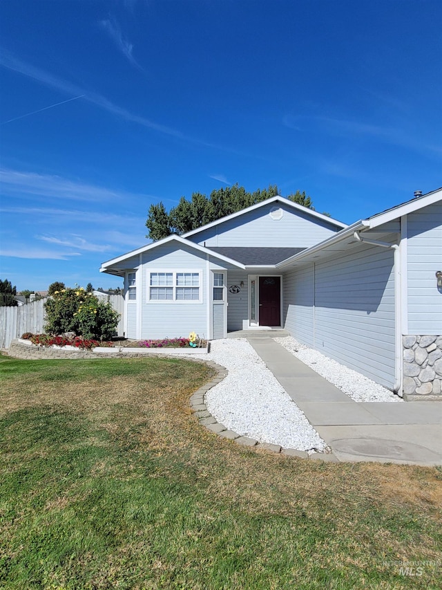 ranch-style house with a front lawn