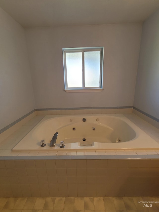 bathroom featuring tiled bath and tile patterned floors