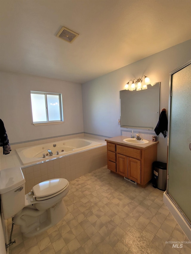 full bathroom featuring independent shower and bath, vanity, and toilet