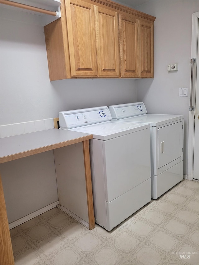 laundry room with cabinets and washing machine and dryer