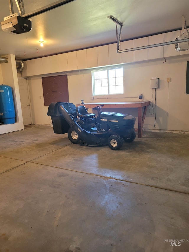 garage with a garage door opener and electric panel