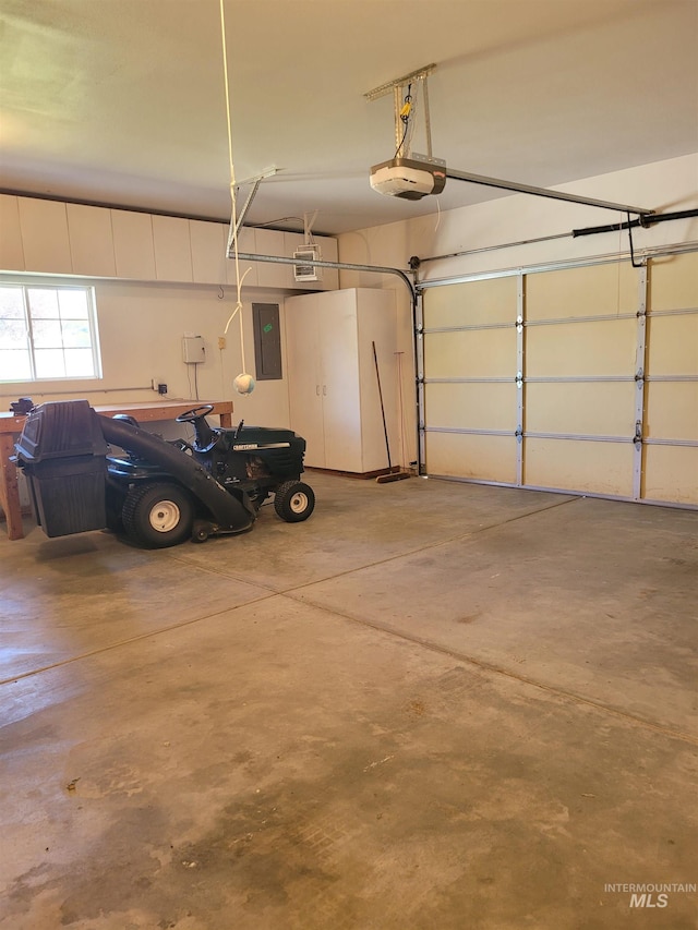 garage featuring a garage door opener and electric panel