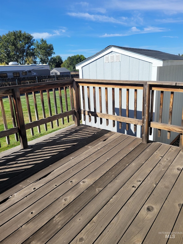 wooden deck featuring a yard