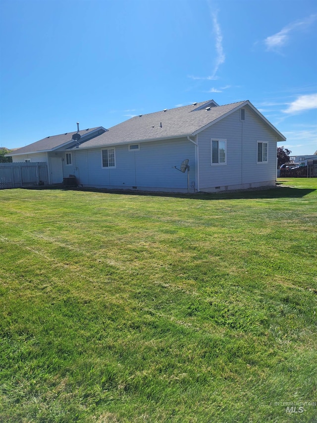 rear view of property with a lawn