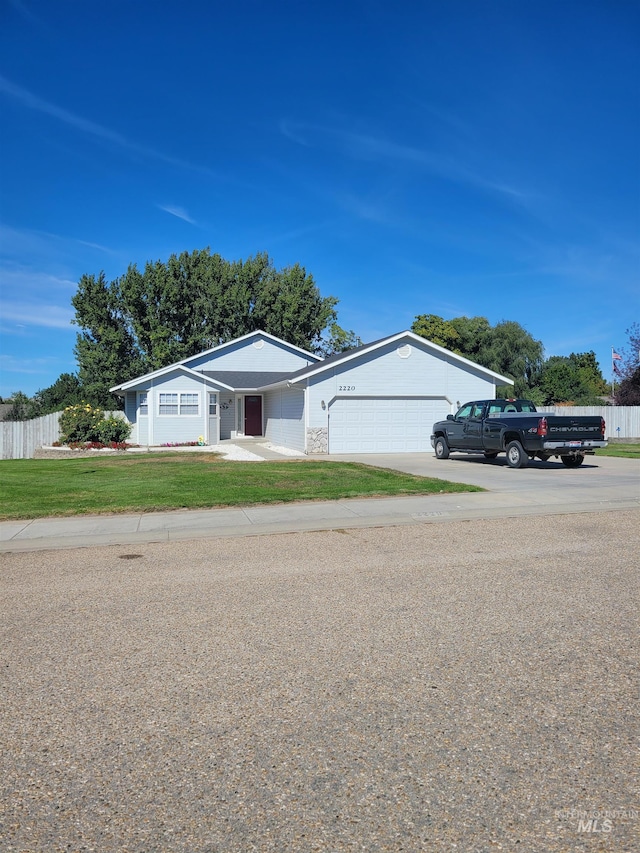 ranch-style home featuring a garage and a front yard