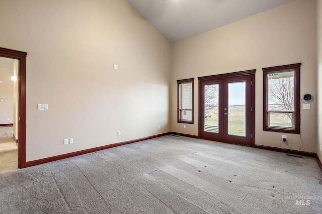 interior space with visible vents, french doors, high vaulted ceiling, and baseboards