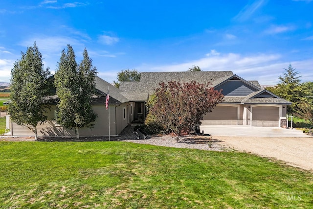 obstructed view of property with concrete driveway, a garage, and a front lawn