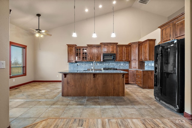 kitchen with brown cabinets, black appliances, a sink, decorative backsplash, and ceiling fan