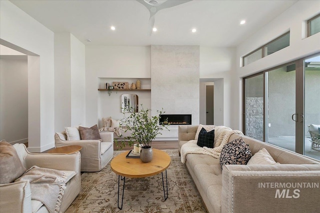 living room featuring a fireplace and light wood-type flooring