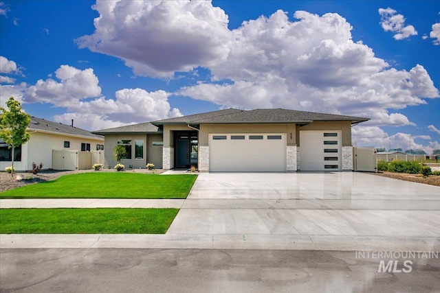 prairie-style home featuring a garage and a front yard