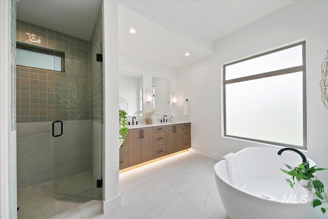 bathroom with plus walk in shower, vanity, and a wealth of natural light