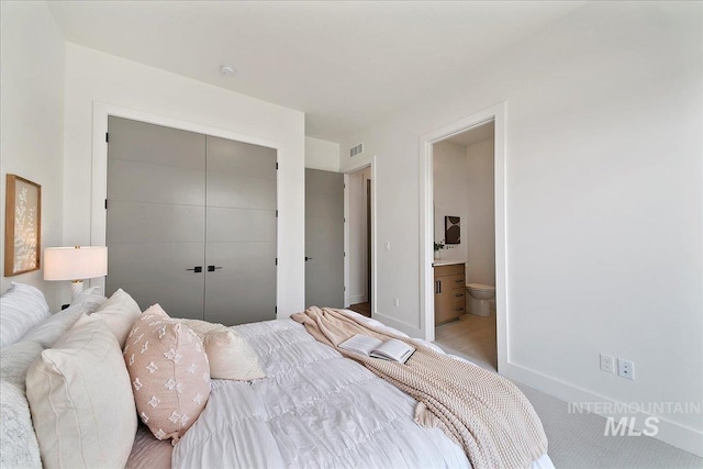 bedroom featuring connected bathroom and a closet