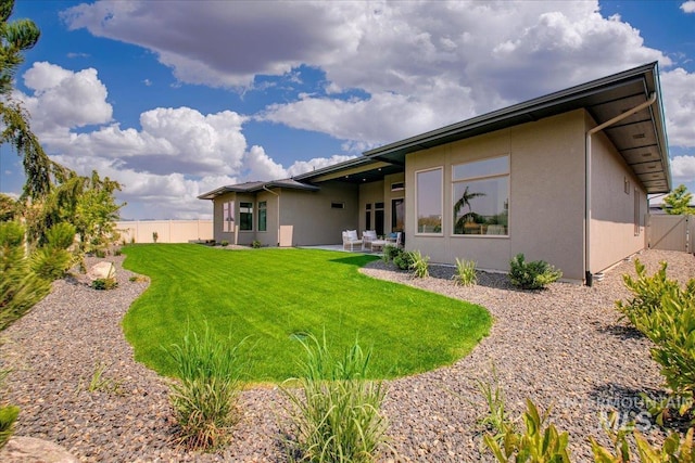 rear view of property with a yard