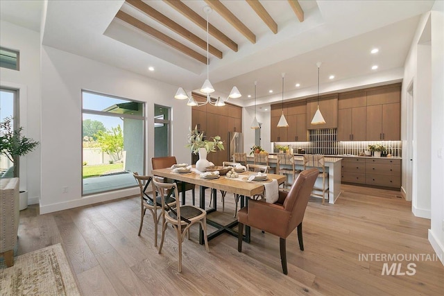 dining area featuring light hardwood / wood-style flooring, beamed ceiling, and an inviting chandelier