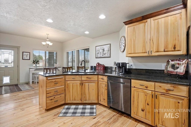 kitchen with sink, a textured ceiling, an inviting chandelier, dishwasher, and kitchen peninsula